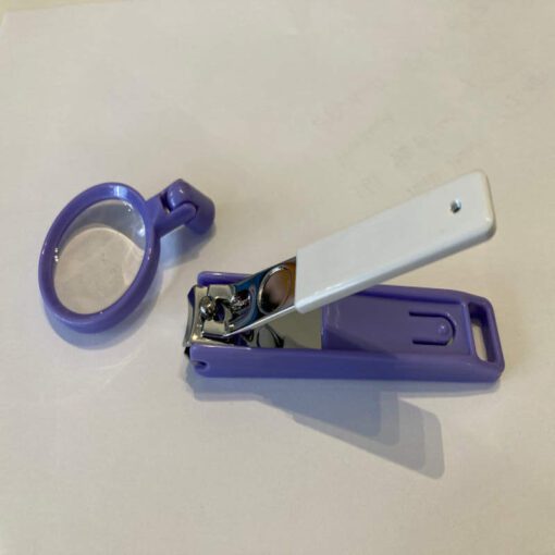 Nail clippers with magnetic magnifier