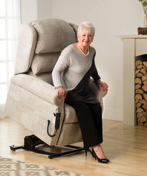 Woman rising using a rise and recline chair
