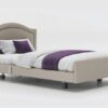 Signature upholstered profiling care bed with arched headboard.