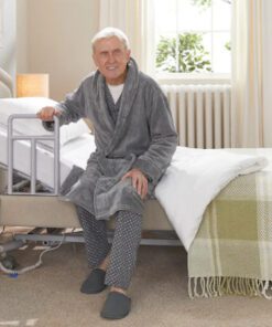 Man using side grab rail to get out of bed