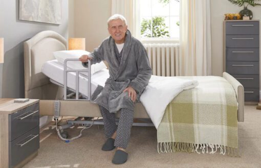 Man using side grab rail to get out of bed